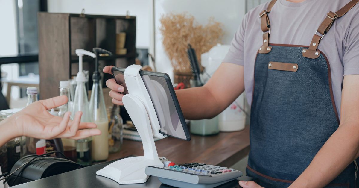 Restaurant employee adding customer order to POS system